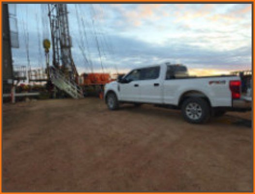 Dakota Chemical field truck staged beside oilfield equipment